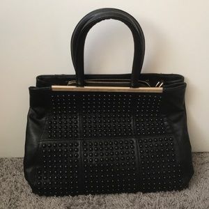 Black Studded Pleather Purse with Gold Bar.